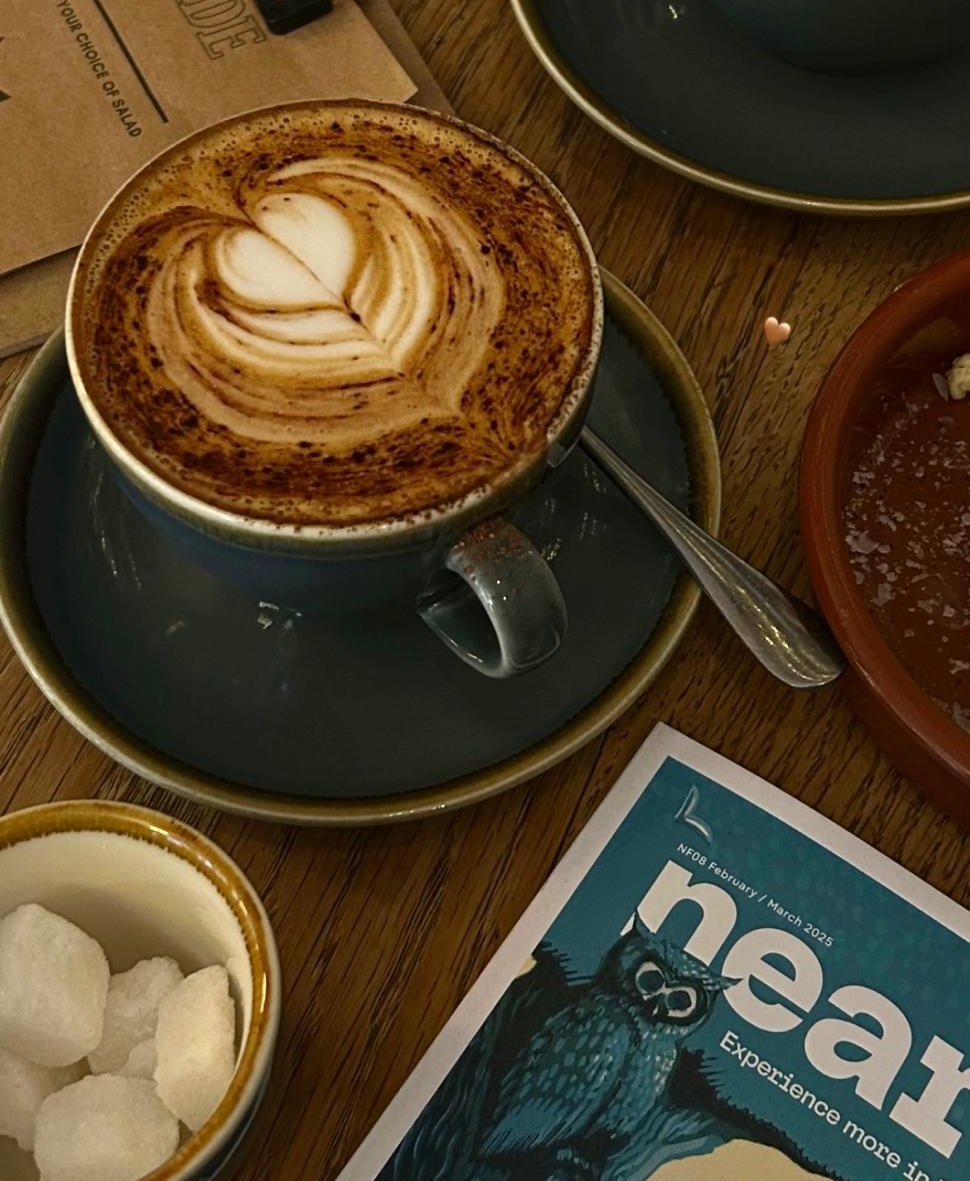 Nearfield magazine and coffee on a wooden table